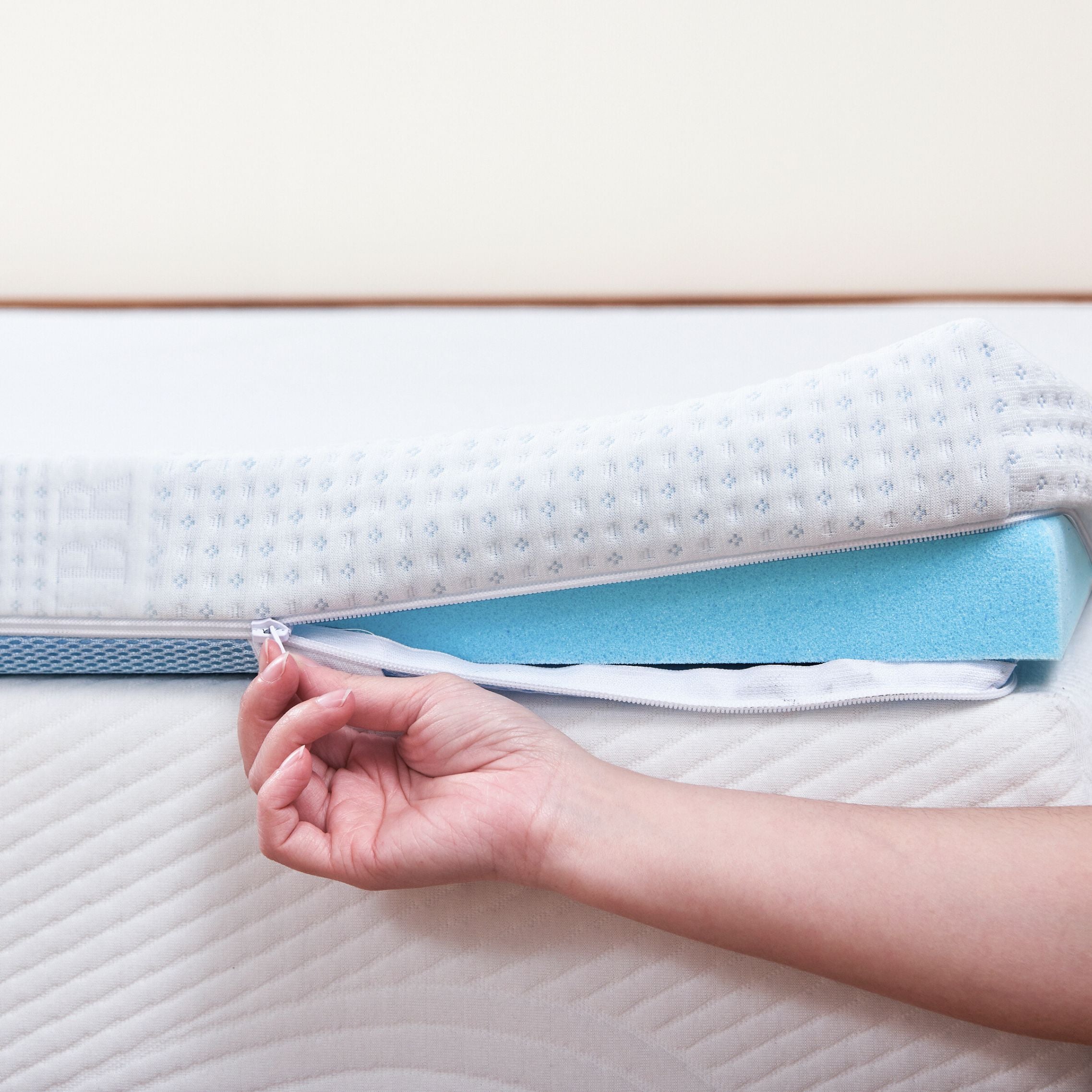 Unzipping topper's removable cover